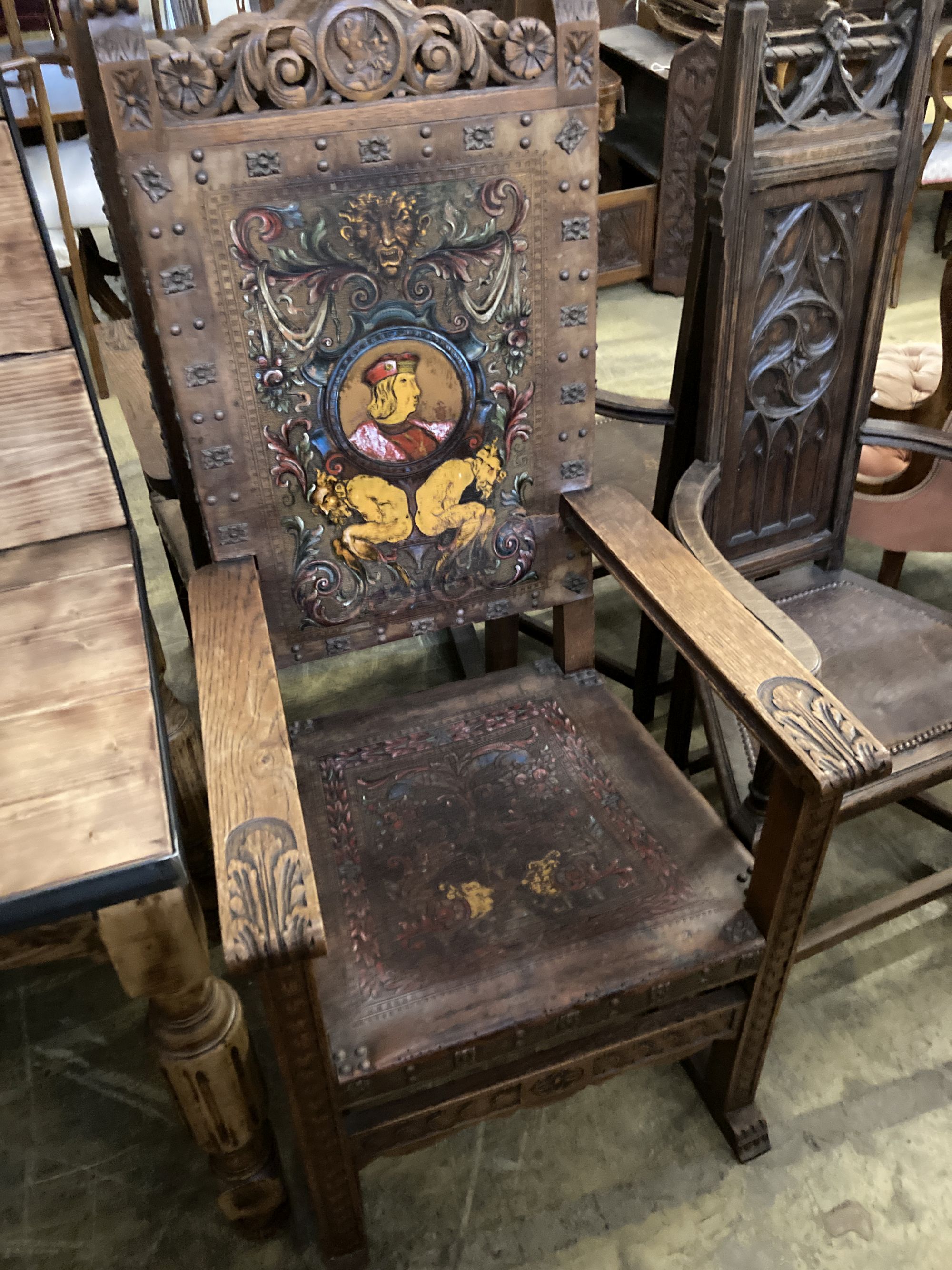 A pair of Spanish oak elbow chairs, width 62cm, depth 52cm, height 128cm
